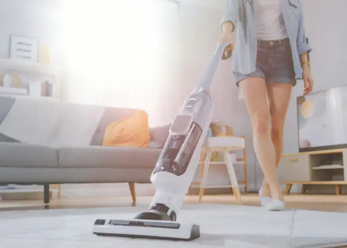 Woman vacuuming with a cordless vacuum
