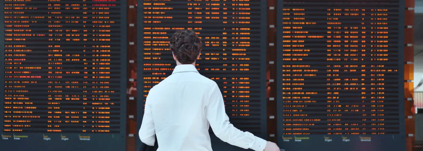 Man looking at departures board at airport